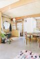 A detached two-car garage was transformed into this bright and roomy backyard cottage with a studio floor plan. | www.facebook.com/SmallHouseBliss