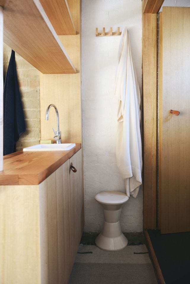 A detached two-car garage was transformed into this bright and roomy backyard cottage with a studio floor plan. | www.facebook.com/SmallHouseBliss