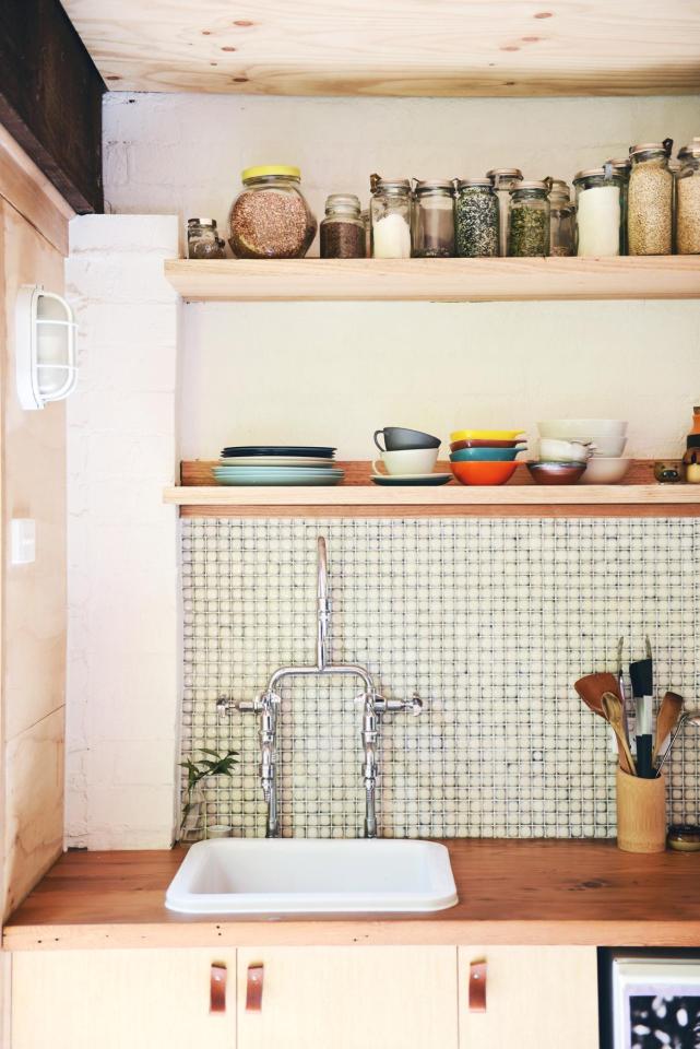 A detached two-car garage was transformed into this bright and roomy backyard cottage with a studio floor plan. | www.facebook.com/SmallHouseBliss