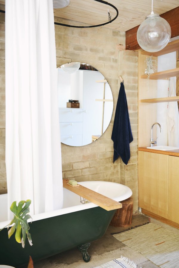 A detached two-car garage was transformed into this bright and airy backyard cottage with a studio floor plan. | www.facebook.com/SmallHouseBliss