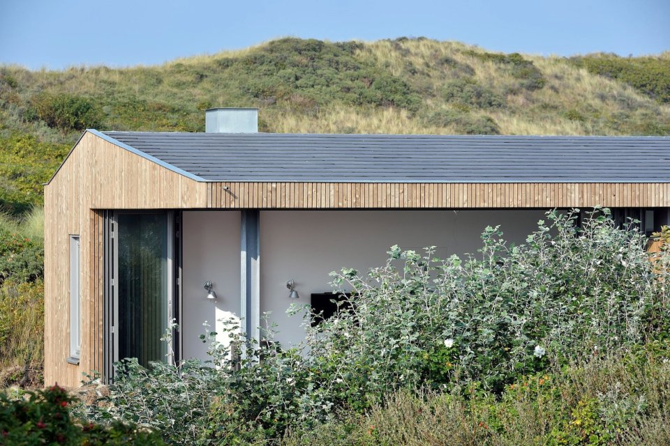 This vacation cottage sits on the sand dunes of a Dutch coastal island. It has two small bedrooms in 646 sq ft. | www.facebook.com/SmallHouseBliss