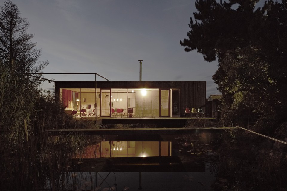 This small house sits at the edge of a pond surrounded by mature landscaping. It has one bedroom in 538 sq ft. | www.facebook.com/SmallHouseBliss