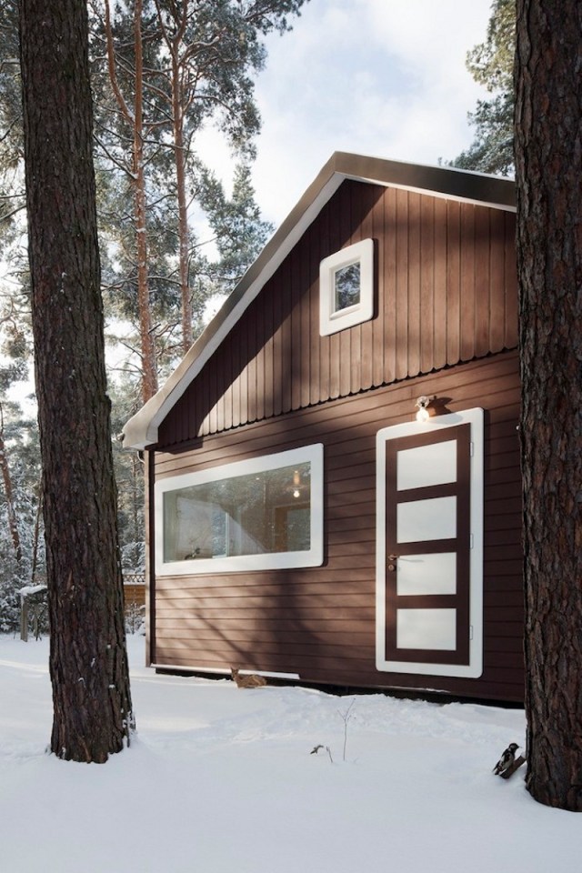 A small "gingerbread house" in the forest. The 667 sq ft cottage has a loft divided into two sleeping spaces. | www.facebook.com/SmallHouseBliss