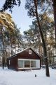 A small "gingerbread house" in the forest. The 667 sq ft cottage has a loft divided into two sleeping spaces. | www.facebook.com/SmallHouseBliss