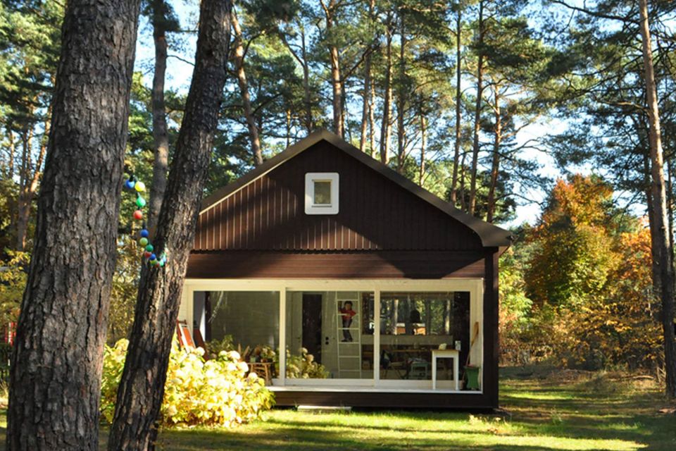 A small "gingerbread house" in the forest. The 667 sq ft cottage has a loft divided into two sleeping spaces. | www.facebook.com/SmallHouseBliss