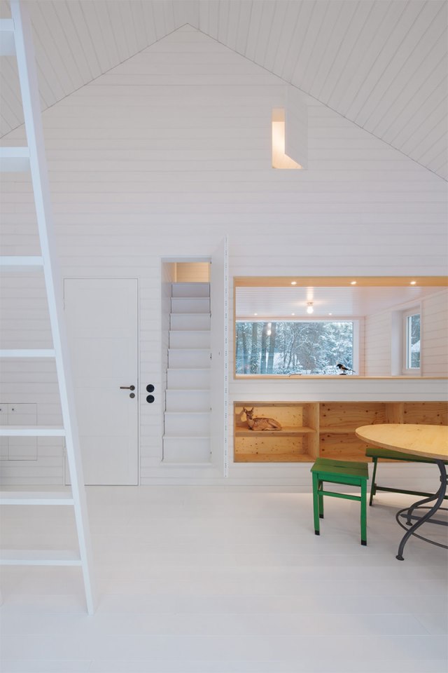 A small "gingerbread house" in the forest. The 667 sq ft cottage has a loft divided into two sleeping spaces. | www.facebook.com/SmallHouseBliss