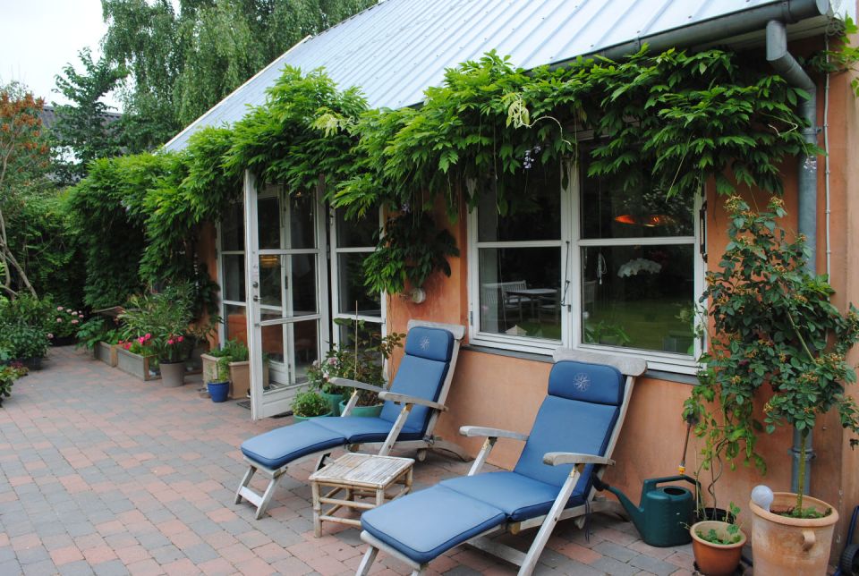 This cottage in Denmark opens to a lushly-planted garden. It is 861 sq ft with a loft bedroom and the potential for a second bedroom downstairs. | www.facebook.com/SmallHouseBliss