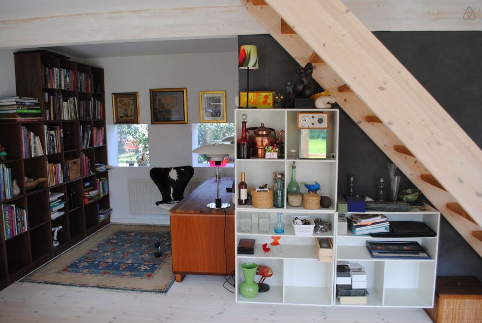 This cottage in Denmark opens to a lushly-planted garden. It is 861 sq ft with a loft bedroom and the potential for a second bedroom downstairs. | www.facebook.com/SmallHouseBliss