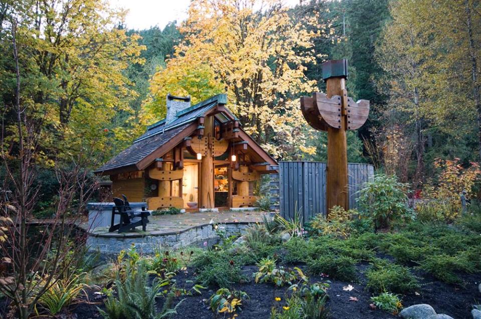 "The Totems" is a small log cabin with an almost mystical quality. It has 400 sq ft plus a sleeping loft. | www.facebook.com/SmallHouseBliss