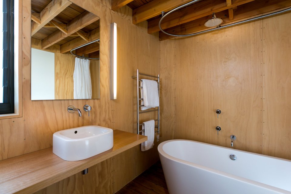 This New Zealand "bach" (a simple vacation home) has a 592 sq ft main level plus two attic loft bedrooms. | www.facebook.com/SmallHouseBliss