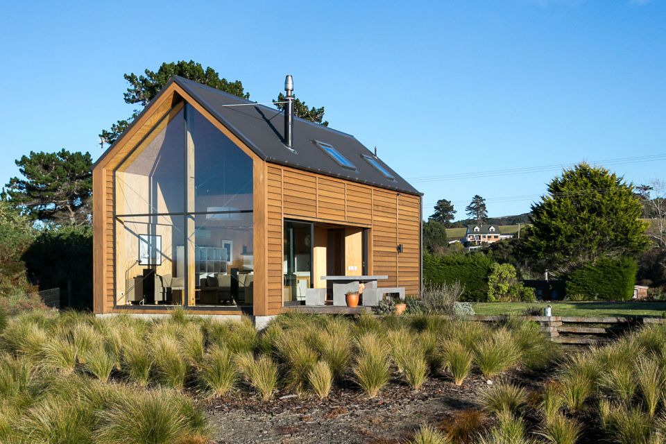 This New Zealand "bach" (a simple vacation home) has a 592 sq ft main level plus two attic loft bedrooms. | www.facebook.com/SmallHouseBliss
