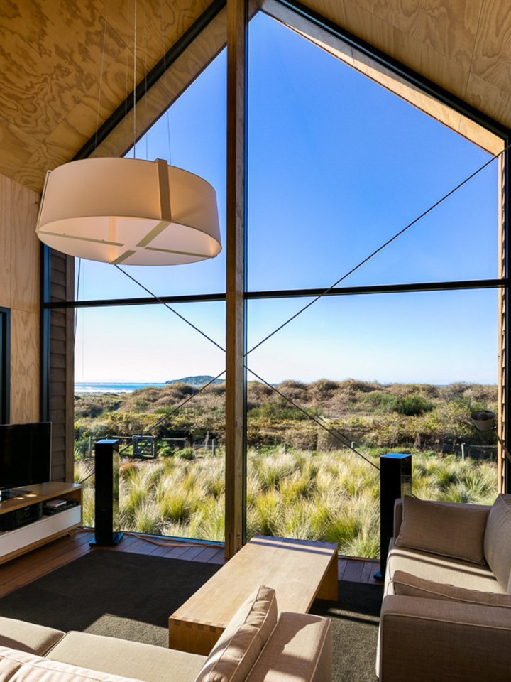 This New Zealand "bach" (a simple vacation home) has a 592 sq ft main level plus two attic loft bedrooms. | www.facebook.com/SmallHouseBliss