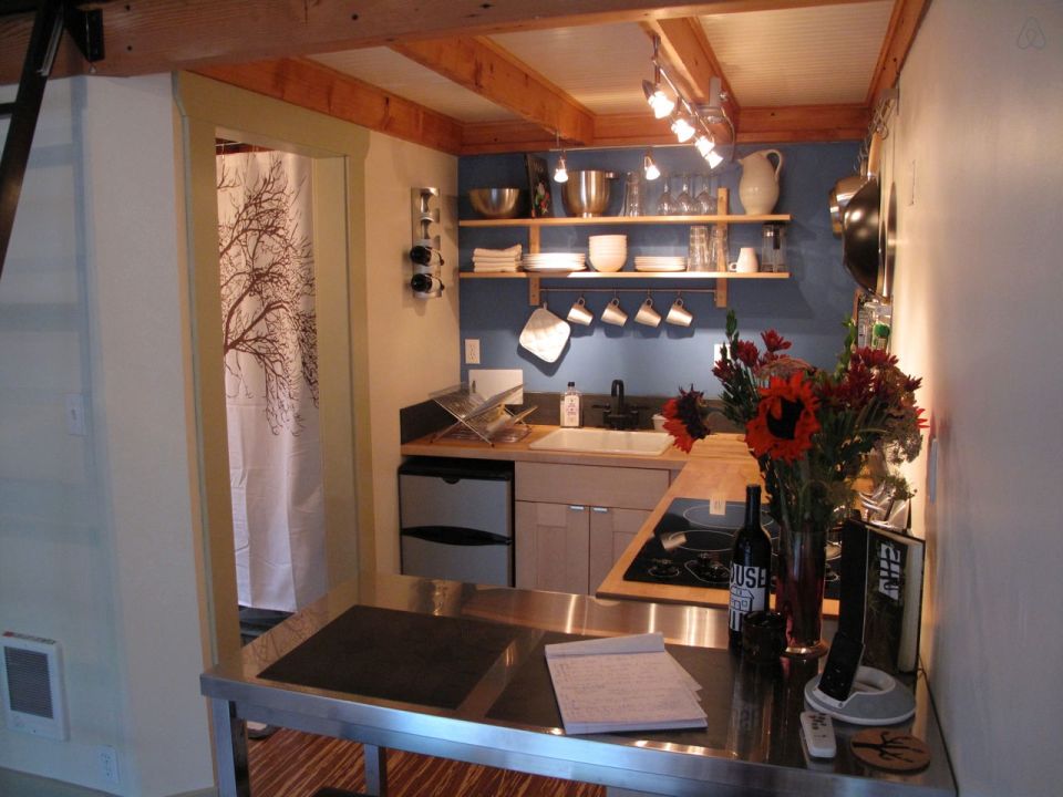 This tiny backyard cottage in Portland, Oregon, is likely a converted garage. It has 300 sq ft plus a sleeping loft. | www.facebook.com/SmallHouseBliss