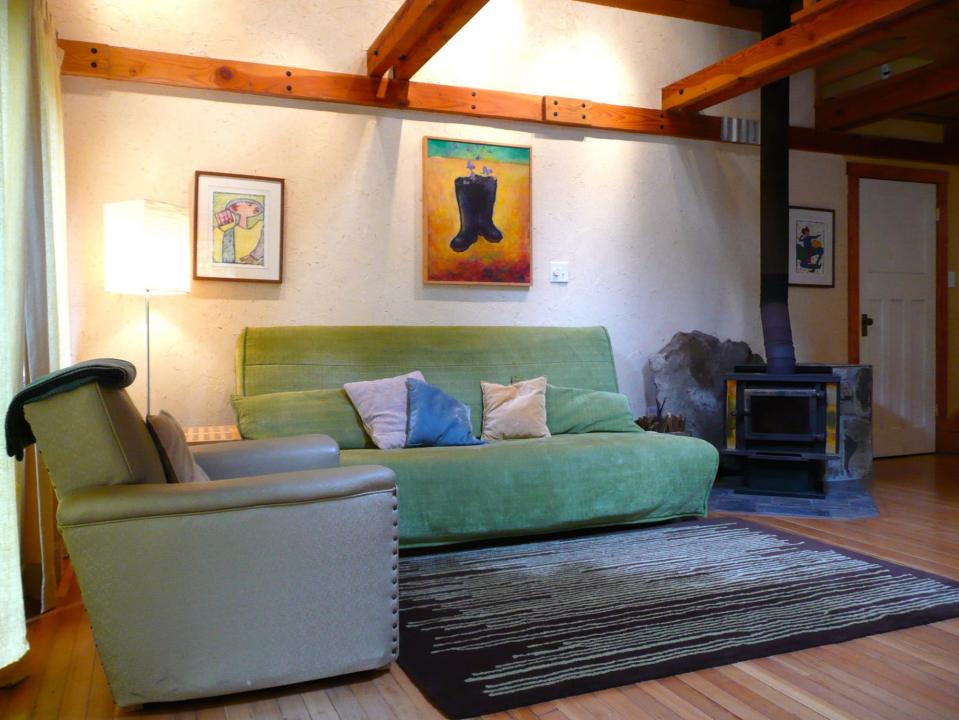 Artwood Cottage, a cozy hideaway in the woods, features hand-plastered walls and custom woodwork. It has one lofted bedroom. | www.facebook.com/SmallHouseBliss