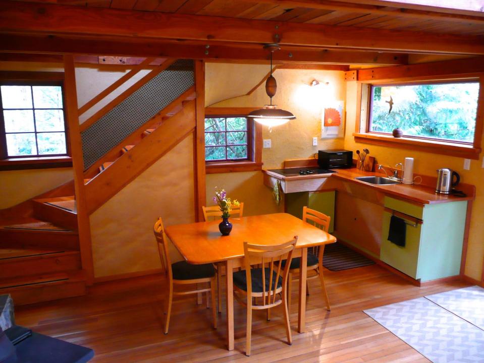 Artwood Cottage, a cozy hideaway in the woods, features hand-plastered walls and custom woodwork. It has one lofted bedroom. | www.facebook.com/SmallHouseBliss