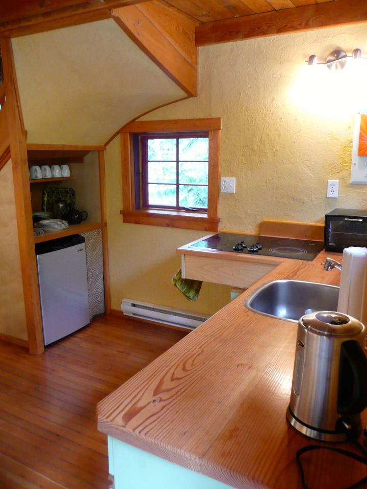 Artwood Cottage, a cozy hideaway in the woods, features hand-plastered walls and custom woodwork. It has one lofted bedroom. | www.facebook.com/SmallHouseBliss