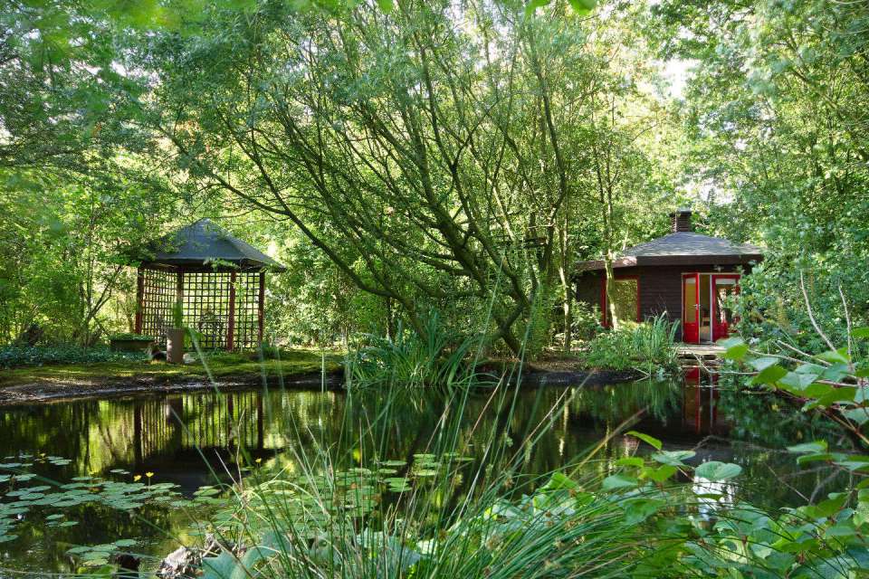 "Forest House" is a yurt-like tiny cottage with rafters radiating out from the center and an open studio floor plan. | www.facebook.com/SmallHouseBliss