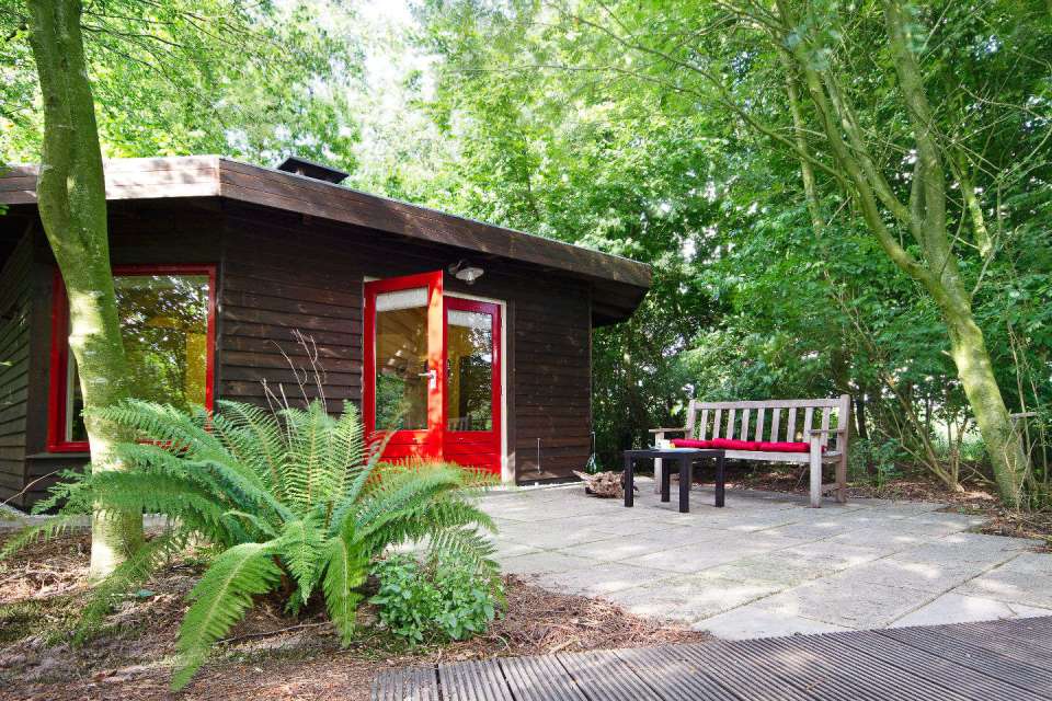 "Forest House" is a yurt-like tiny cottage with rafters radiating out from the center and an open studio floor plan. | www.facebook.com/SmallHouseBliss