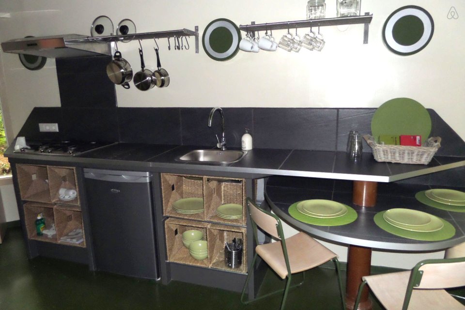 "Forest House" is a yurt-like tiny cottage with rafters radiating out from the center and an open studio floor plan. | www.facebook.com/SmallHouseBliss