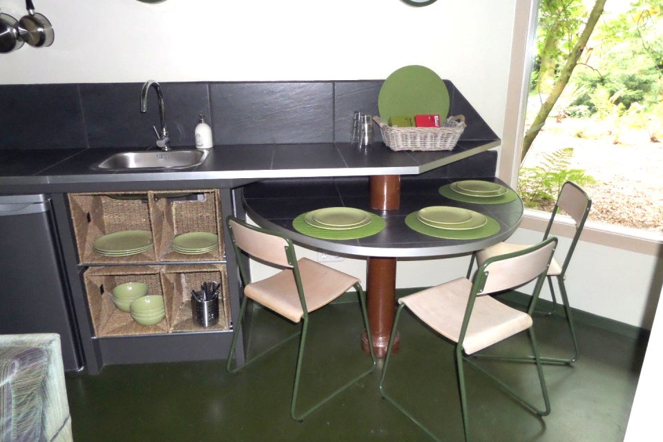 "Forest House" is a yurt-like tiny cottage with rafters radiating out from the center and an open studio floor plan. | www.facebook.com/SmallHouseBliss