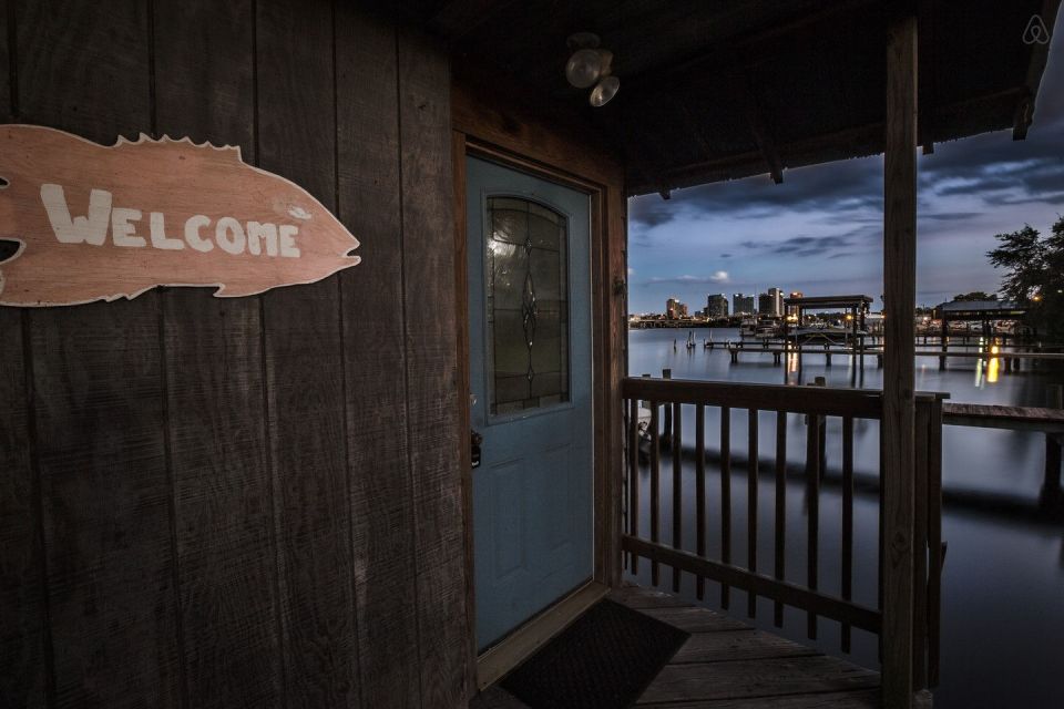 A ramshackle exterior conceals a modern one-bedroom home in this dock house perched over a river within sight of downtown Tampa, Florida. | www.facebook.com/SmallHouseBliss