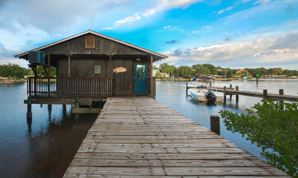 A ramshackle exterior conceals a modern one-bedroom home in this dock house perched over a river within sight of downtown Tampa, Florida. | www.facebook.com/SmallHouseBliss