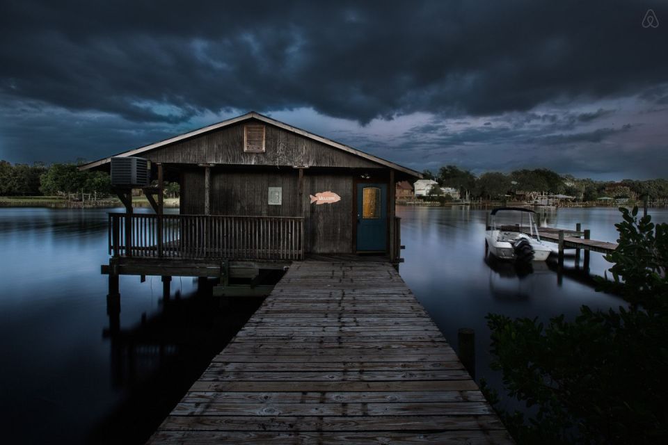 A ramshackle exterior conceals a modern one-bedroom home in this dock house perched over a river within sight of downtown Tampa, Florida. | www.facebook.com/SmallHouseBliss