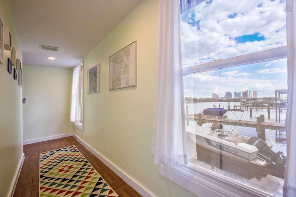 A ramshackle exterior conceals a modern one-bedroom home in this dock house perched over a river within sight of downtown Tampa, Florida. | www.facebook.com/SmallHouseBliss