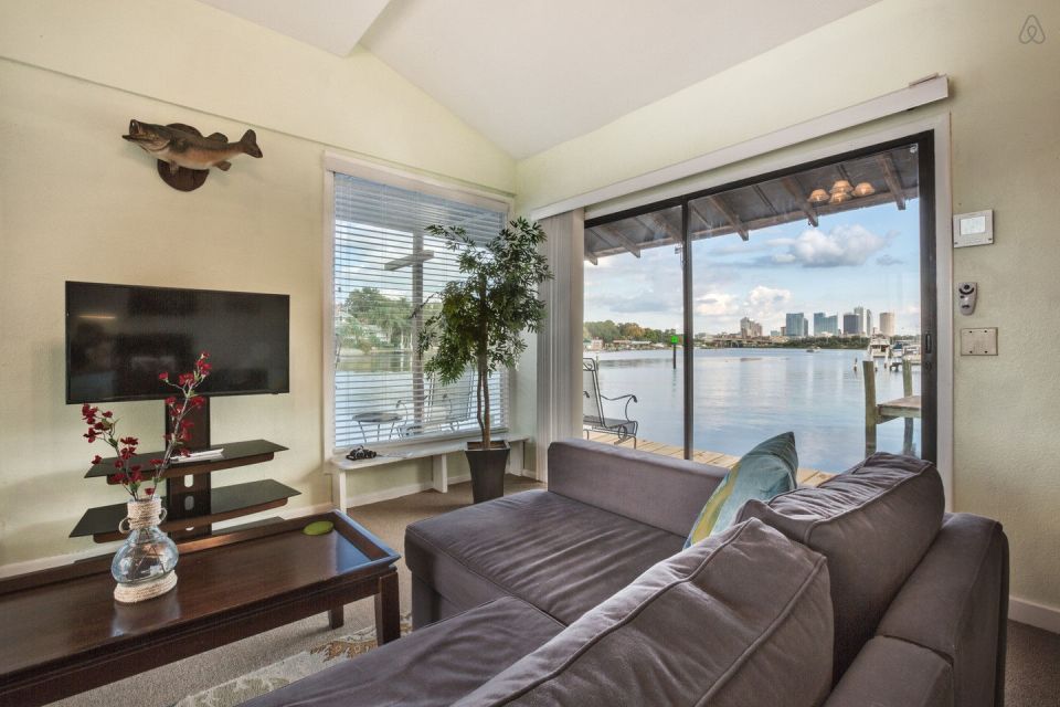 A ramshackle exterior conceals a modern one-bedroom home in this dock house perched over a river within sight of downtown Tampa, Florida. | www.facebook.com/SmallHouseBliss