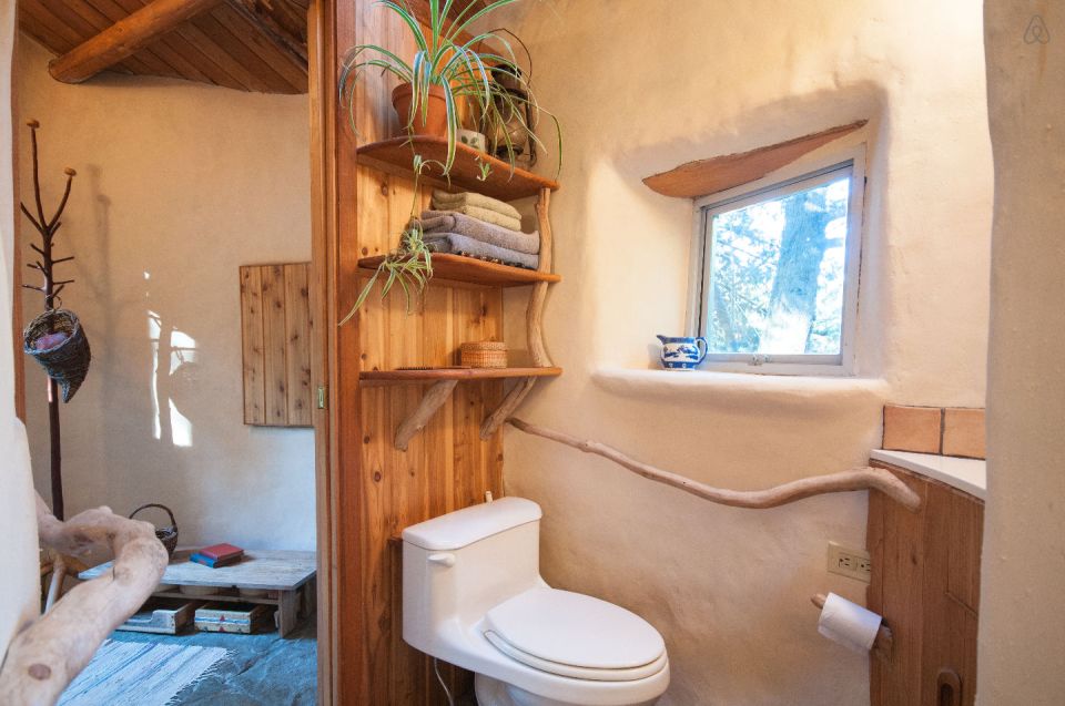A one-bedroom storybook cottage with curved walls sculpted from cob, a mixture of clay, sand and straw. | www.facebook.com/SmallHouseBliss