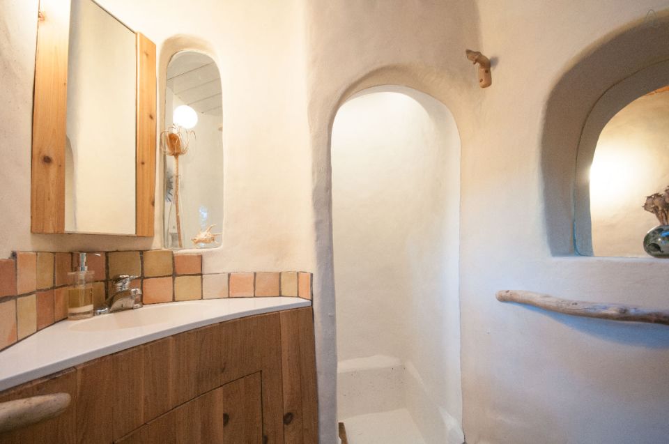 A one-bedroom storybook cottage with curved walls sculpted from cob, a mixture of clay, sand and straw. | www.facebook.com/SmallHouseBliss