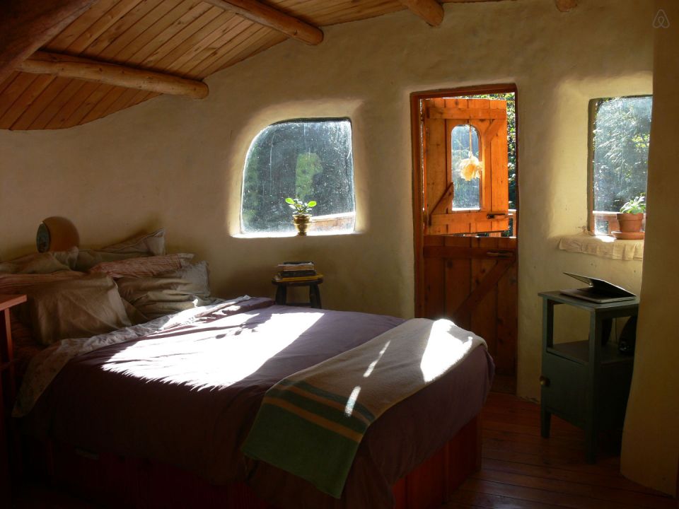 A one-bedroom storybook cottage with curved walls sculpted from cob, a mixture of clay, sand and straw. | www.facebook.com/SmallHouseBliss