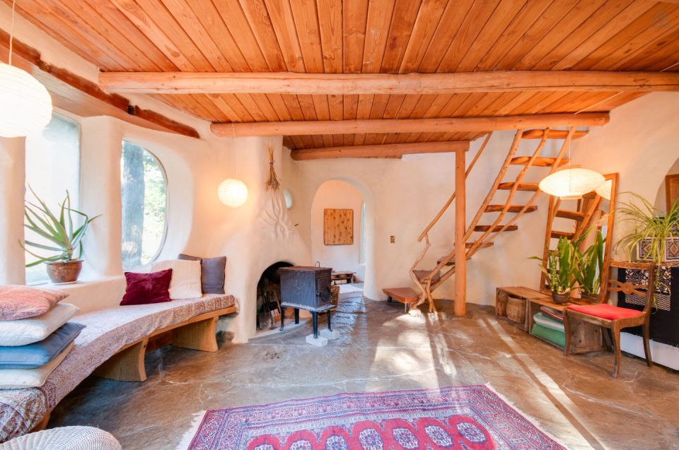 A one-bedroom storybook cottage with curved walls sculpted from cob, a mixture of clay, sand and straw. | www.facebook.com/SmallHouseBliss