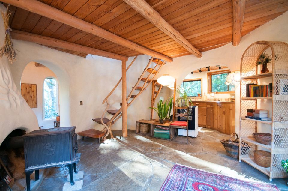 A one-bedroom storybook cottage with curved walls sculpted from cob, a mixture of clay, sand and straw. | www.facebook.com/SmallHouseBliss