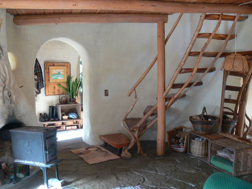 A one-bedroom storybook cottage with curved walls sculpted from cob, a mixture of clay, sand and straw. | www.facebook.com/SmallHouseBliss