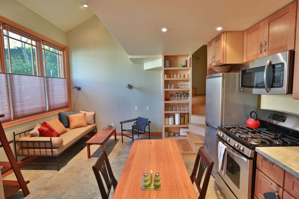 Though just 469 sq ft total, Susan's backyard cottage squeezes in spiral stairs to the loft bedroom. | www.facebook.com/SmallHouseBliss