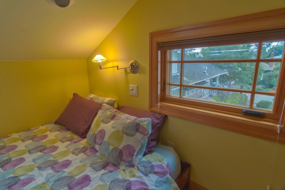 Though just 469 sq ft total, Susan's backyard cottage squeezes in spiral stairs to the loft bedroom. | www.facebook.com/SmallHouseBliss