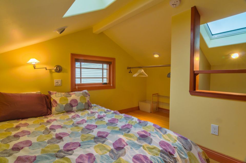 Though just 469 sq ft total, Susan's backyard cottage squeezes in spiral stairs to the loft bedroom. | www.facebook.com/SmallHouseBliss