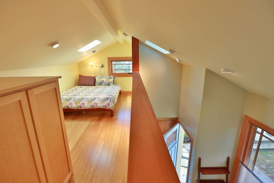 Though just 469 sq ft total, Susan's backyard cottage squeezes in spiral stairs to the loft bedroom. | www.facebook.com/SmallHouseBliss