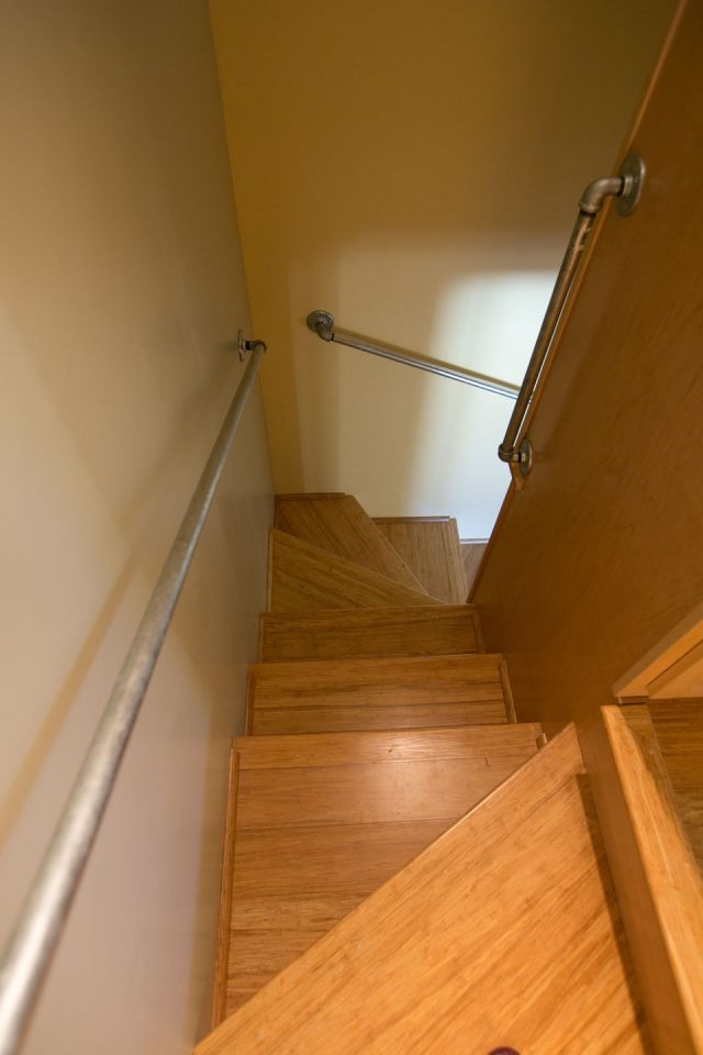 Though just 469 sq ft total, Susan's backyard cottage squeezes in spiral stairs to the loft bedroom. | www.facebook.com/SmallHouseBliss