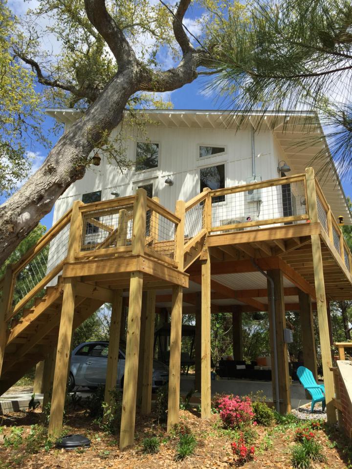 This small beach house, elevated for protection from storm surges, has one bedroom and a loft in a 24’ square footprint. | www.facebook.com/SmallHouseBliss