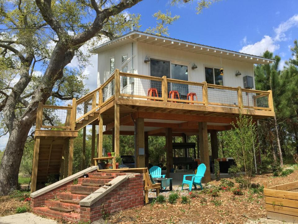 This small beach house, elevated for protection from storm surges, has one bedroom and a loft in a 24’ square footprint. | www.facebook.com/SmallHouseBliss