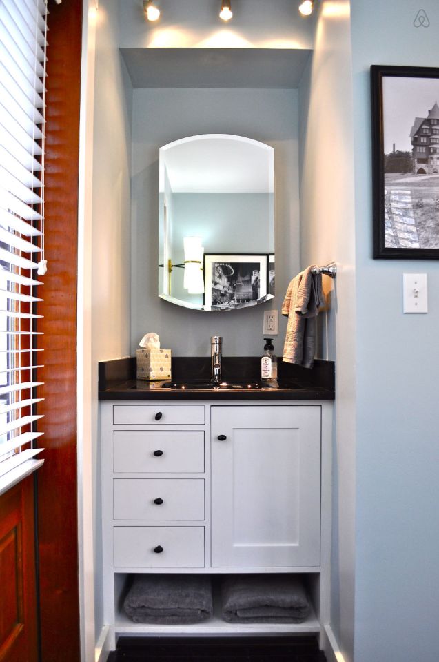 The Birdhouse, a tall and skinny tiny house with the kitchen, living room and bedroom each occupying one of the three floors. | www.facebook.com/SmallHouseBliss