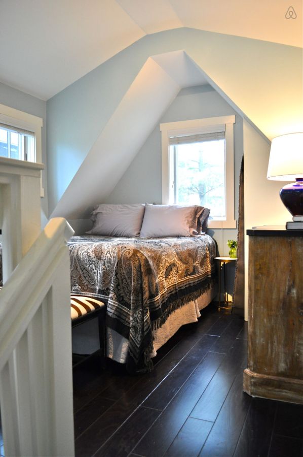 The Birdhouse, a tall and skinny tiny house with the kitchen, living room and bedroom each occupying one of the three floors. | www.facebook.com/SmallHouseBliss