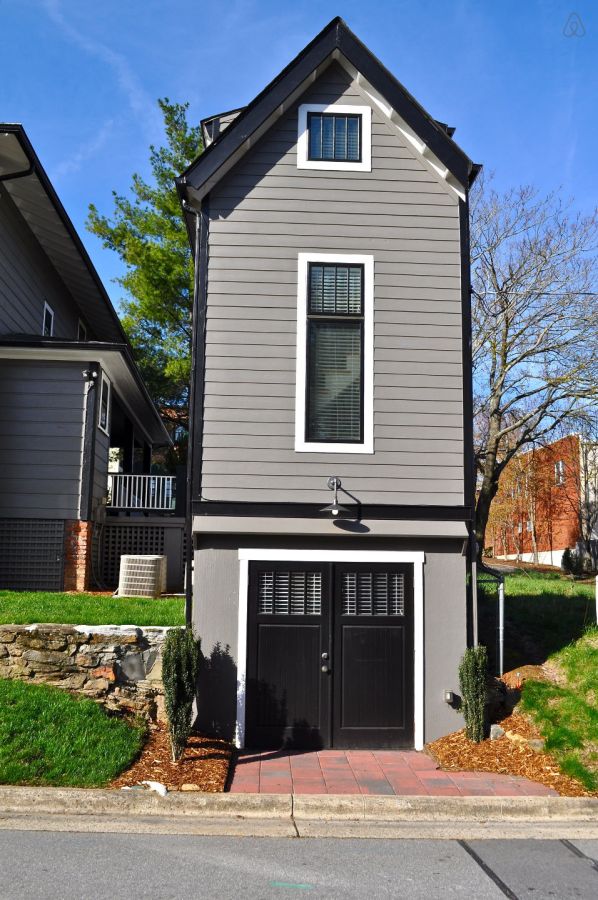 The Birdhouse, a tall and skinny tiny house with the kitchen, living room and bedroom each occupying one of the three floors. | www.facebook.com/SmallHouseBliss