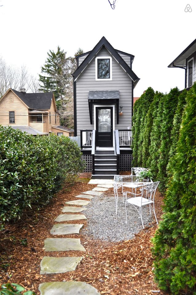 The Birdhouse, a tall and skinny tiny house with the kitchen, living room and bedroom each occupying one of the three floors. | www.facebook.com/SmallHouseBliss