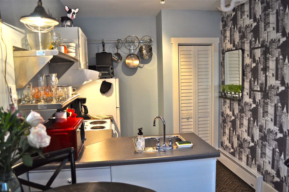 The Birdhouse, a tall and skinny tiny house with the kitchen, living room and bedroom each occupying one of the three floors. | www.facebook.com/SmallHouseBliss