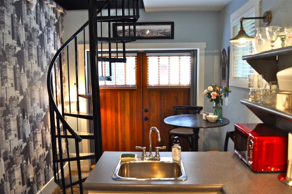 The Birdhouse, a tall and skinny tiny house with the kitchen, living room and bedroom each occupying one of the three floors. | www.facebook.com/SmallHouseBliss