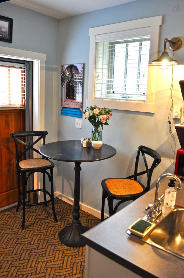 The Birdhouse, a tall and skinny tiny house with the kitchen, living room and bedroom each occupying one of the three floors. | www.facebook.com/SmallHouseBliss