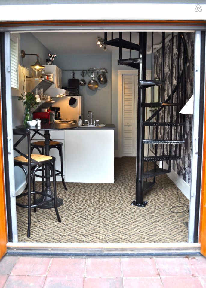 The Birdhouse, a tall and skinny tiny house with the kitchen, living room and bedroom each occupying one of the three floors. | www.facebook.com/SmallHouseBliss